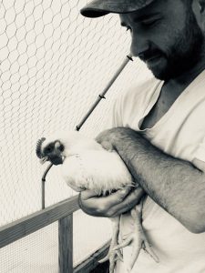 Justin checking on a chicken